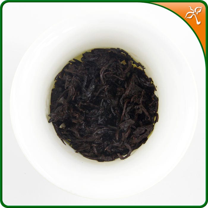Bulang Shan Shu Puerh wet tea leaf in a white gaiwan.