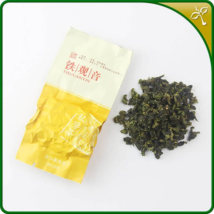 Tieguanyin oolong tea. One sealed 8g silver pouch of our Jiu Jiu Jiu Tieguanyin next to the loose leaf Tieguanyin tea.