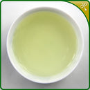 Tie Guan Yin Oolong tea liquor in a small, Chinese gongfu tea cup. Great value loose leaf Tie Guan Yin tea sourced directly from Anxi, Fujian.
