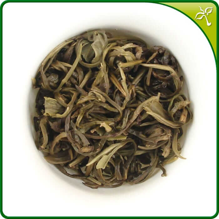 Brewed jasmine tea pearls in a gaiwan. The jasmine green tea pearls open up to show the fine tea leaves.