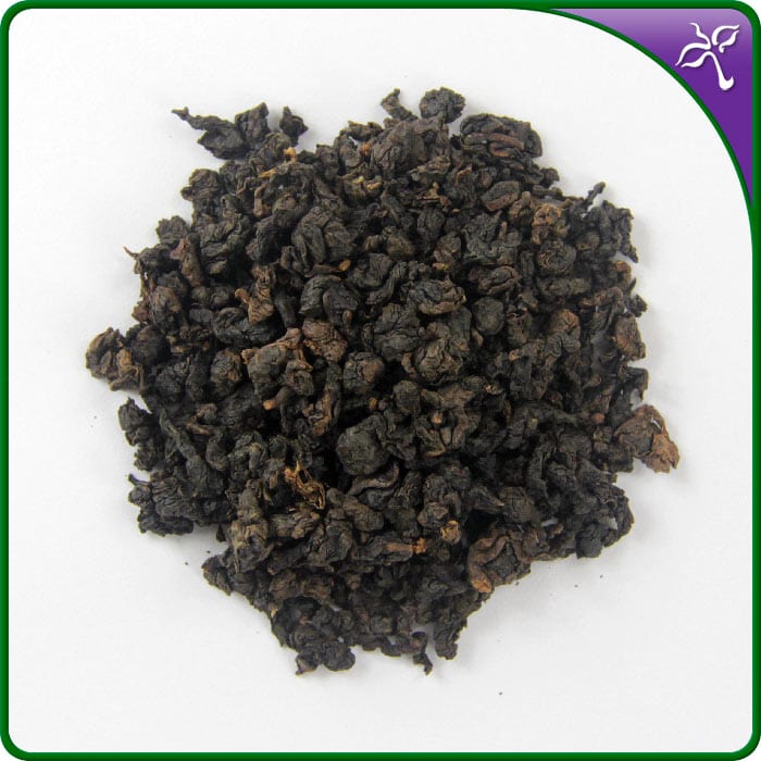 Close-up of dark, tightly rolled dry leaves of Bai Ya Qi Lan Oolong Tea on a white background.
